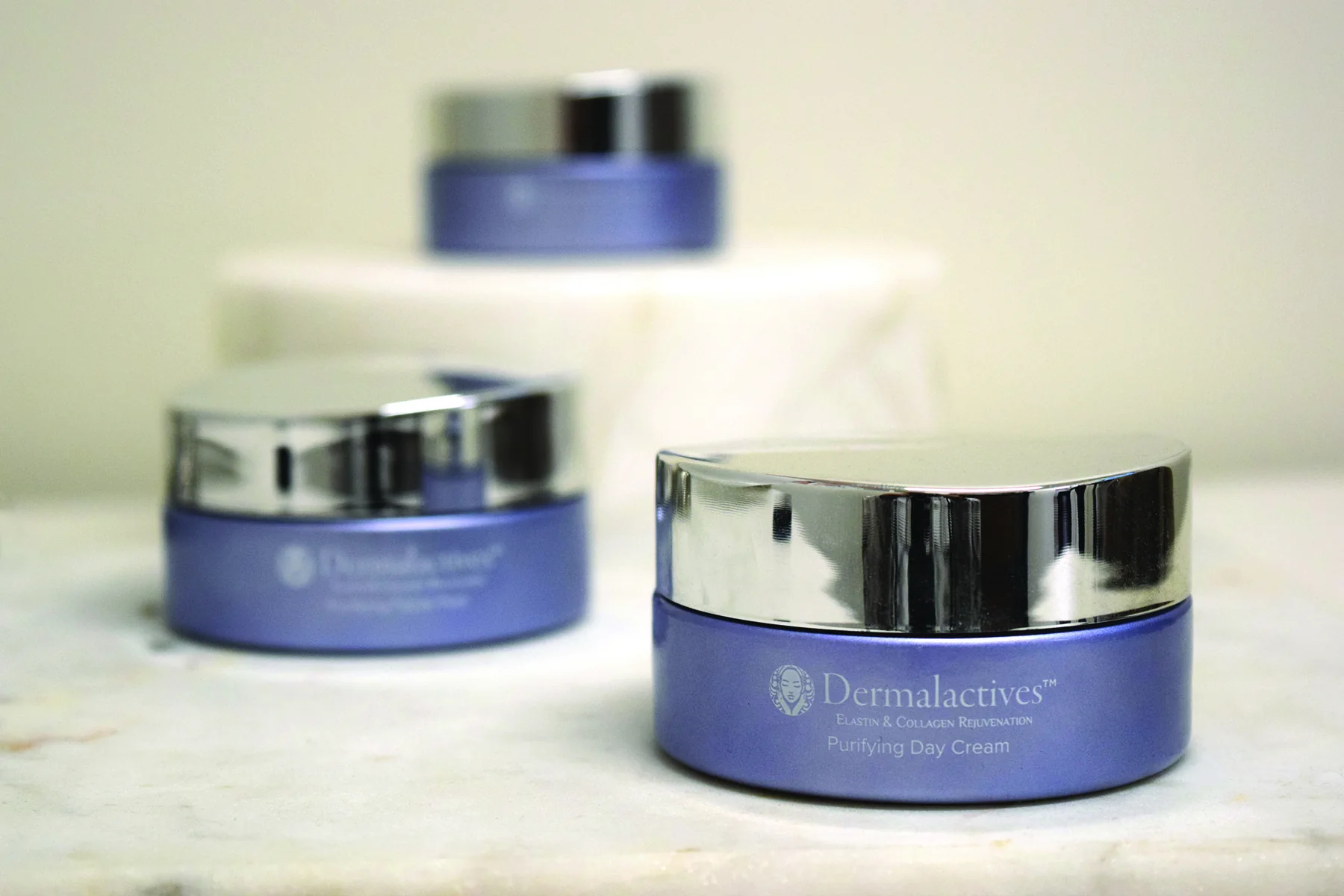 Dermalactives skincare jars arranged for product photography