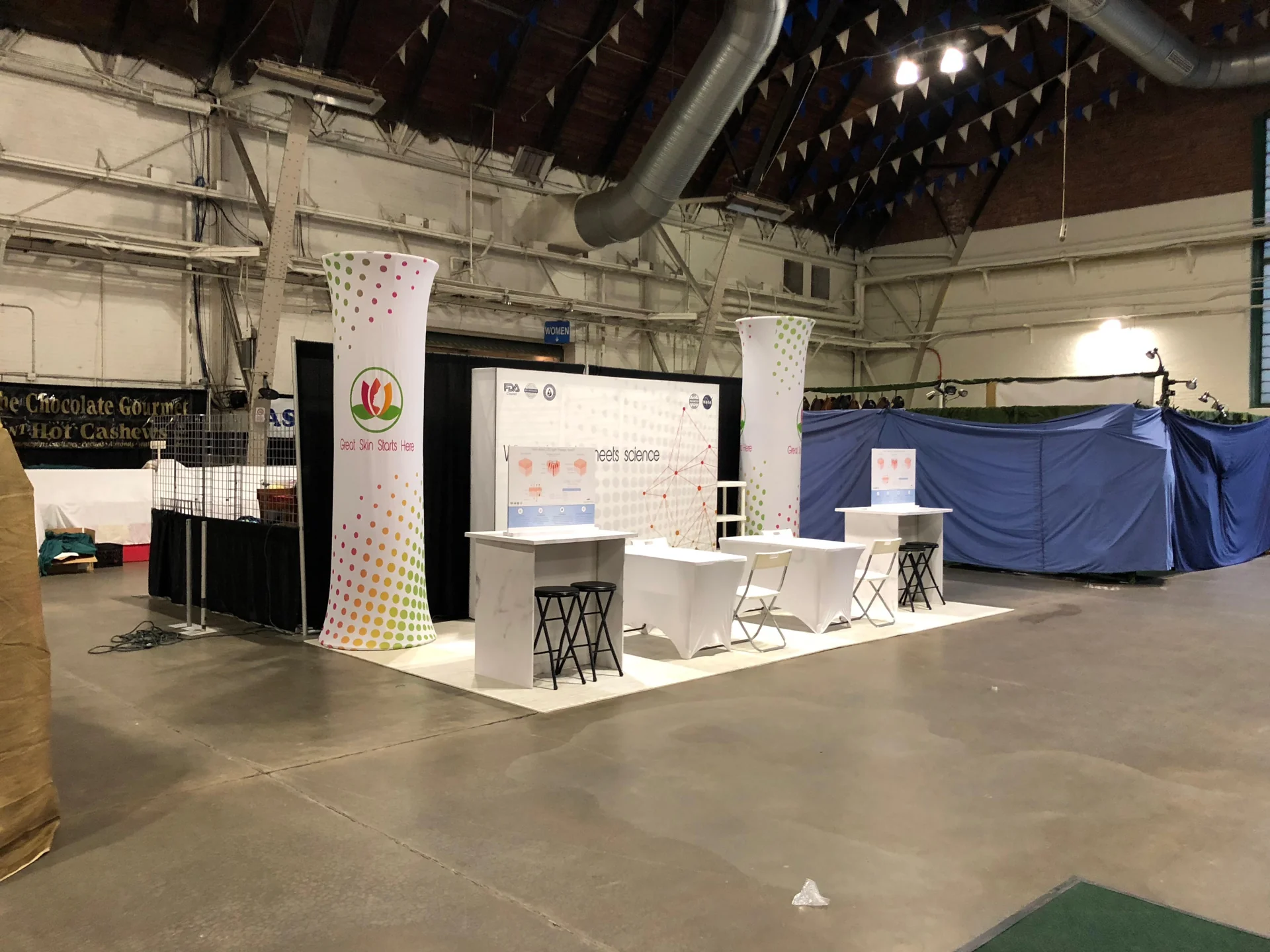 Mazel Marketing white open-format booth with multiple demonstration counters